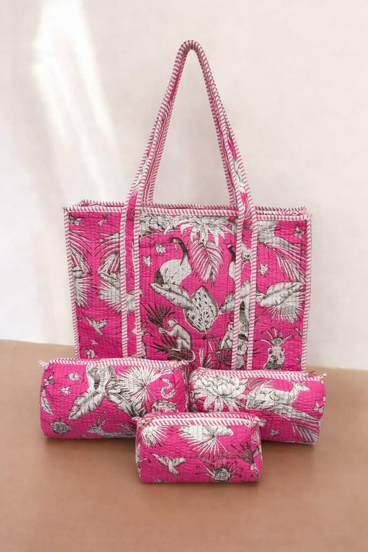 Set of pink bags with white floral patterns on a beige surface