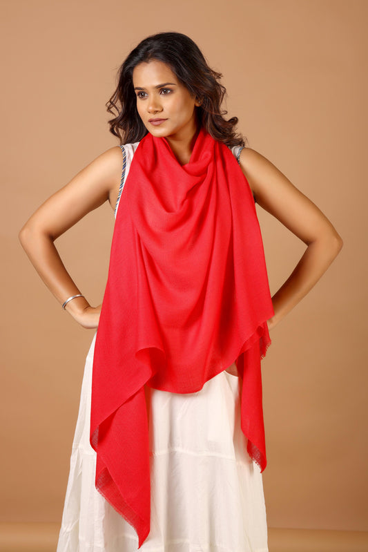 Woman wearing a red scarf over a white