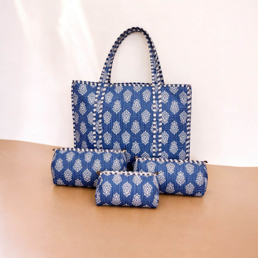 Set of blue patterned bags on a beige surface with a white background