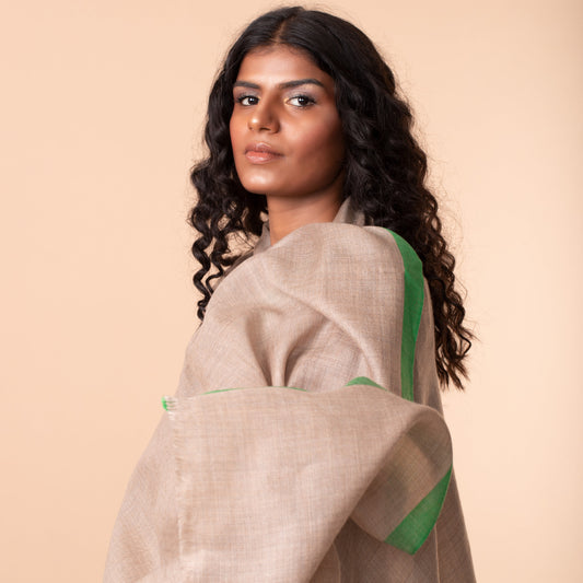 woman draped in a gray and green